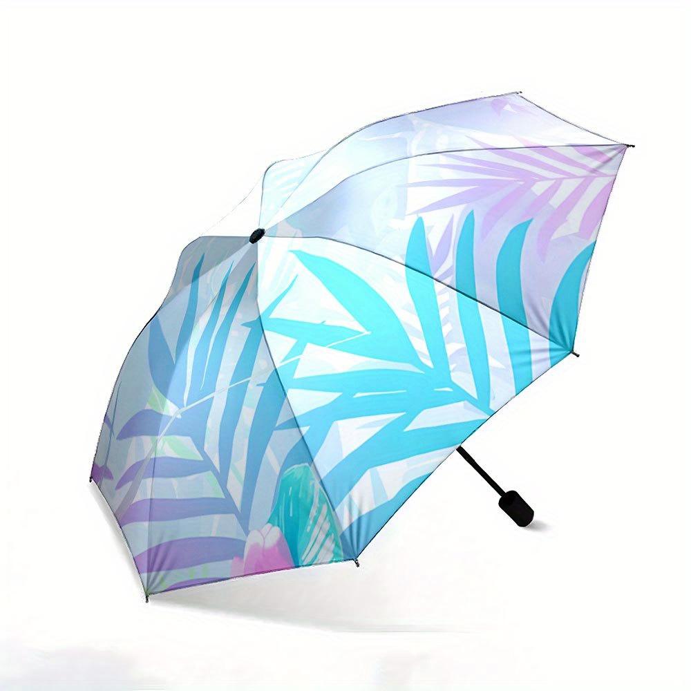 Folding Umbrella The umbrella features pastel-colored tropical leaves and flowers against a light background. Fits Travel, Bac