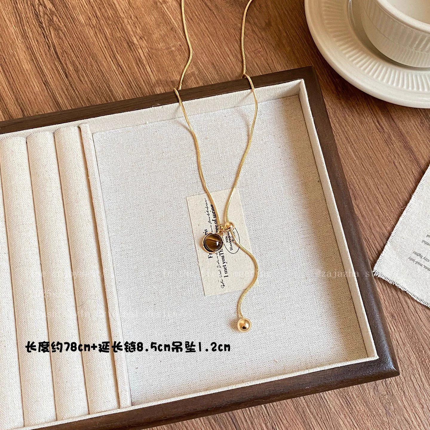 

Gold tiger s eye stone pendant pull necklace women s autumn and winter light luxury niche high-end long sweater chain neck chain