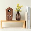 Soothing cuckoo chirps that arrive with the A wooden cuckoo clock that can be placed on a table or mounted on a "Cuckoo Clock" - time. (walnut) wall.