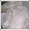 This white glittering hazy mesh fabric can be used for wedding dresses evening gowns and designer clothing fabrics