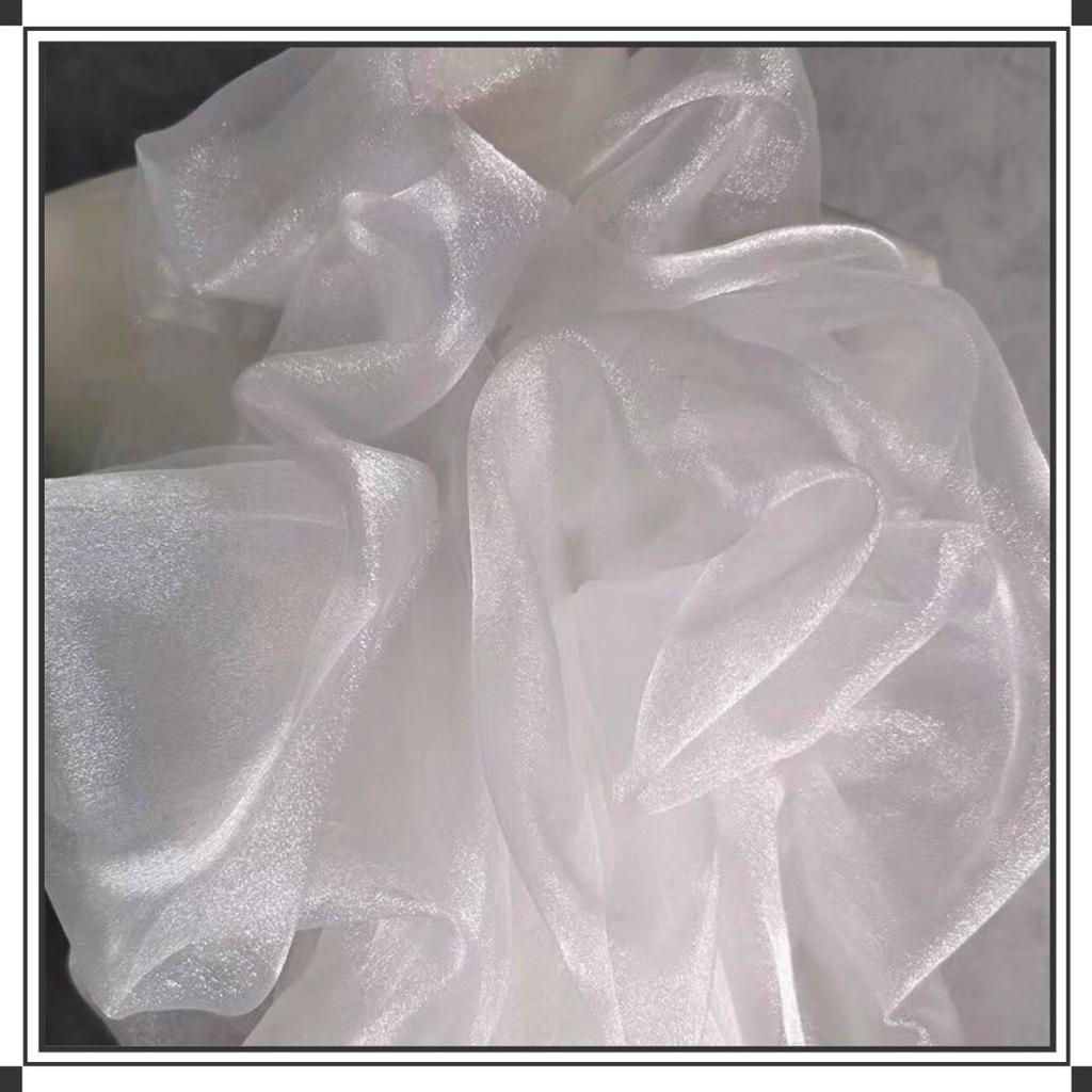 This white glittering hazy mesh fabric can be used for wedding dresses evening gowns and designer clothing fabrics