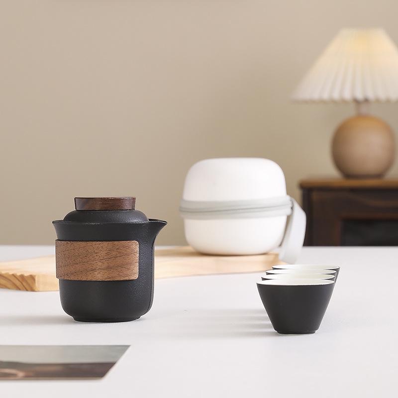 Portable Travel Tea Set: Teapot, Four Cups, and Storage Bag for Outdoor Camping.