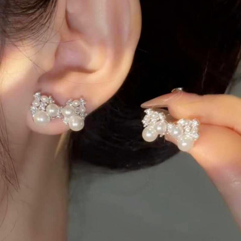 

Silver needle zircon pearl bow stud earrings individual cold wind earrings light luxury high sense earrings design sense niche