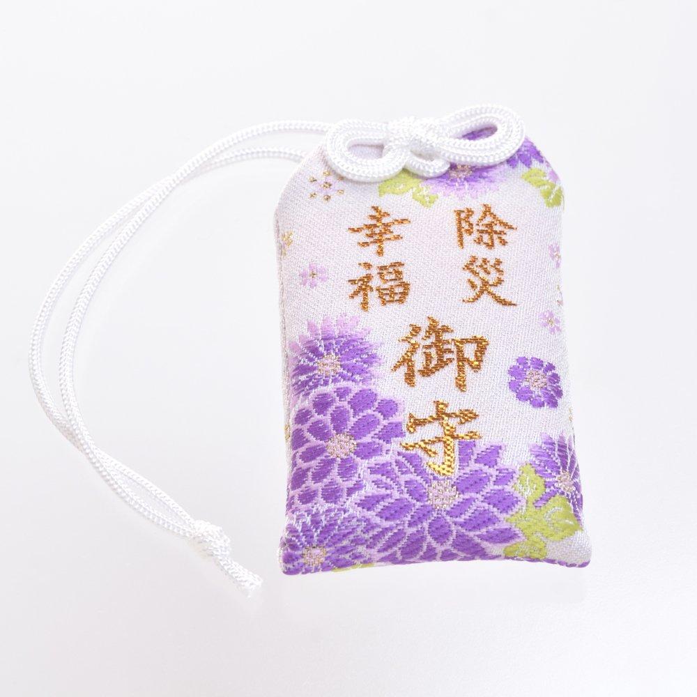 This boxed talisman for good protection from and happiness is a purple skin It has been blessed at Shirasaki Hachimangu Shrine in luck, misfortune,