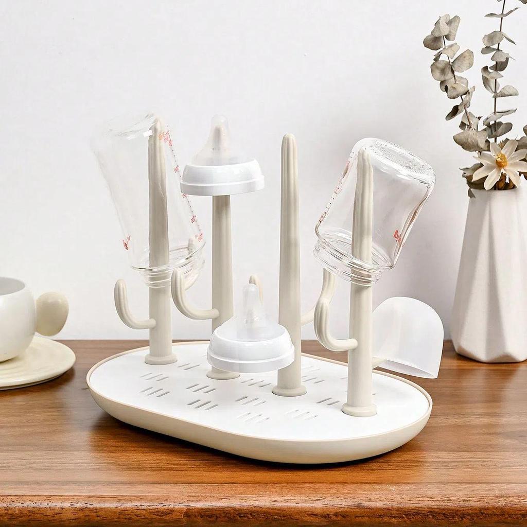 Versatile Baby Bottle Holder & Detachable Drying Rack with Pacifier Slot.