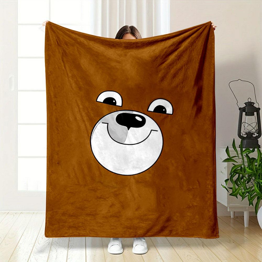 A smiling cartoon bear face on a brown background. for all seasons blanket lunch break throw gift