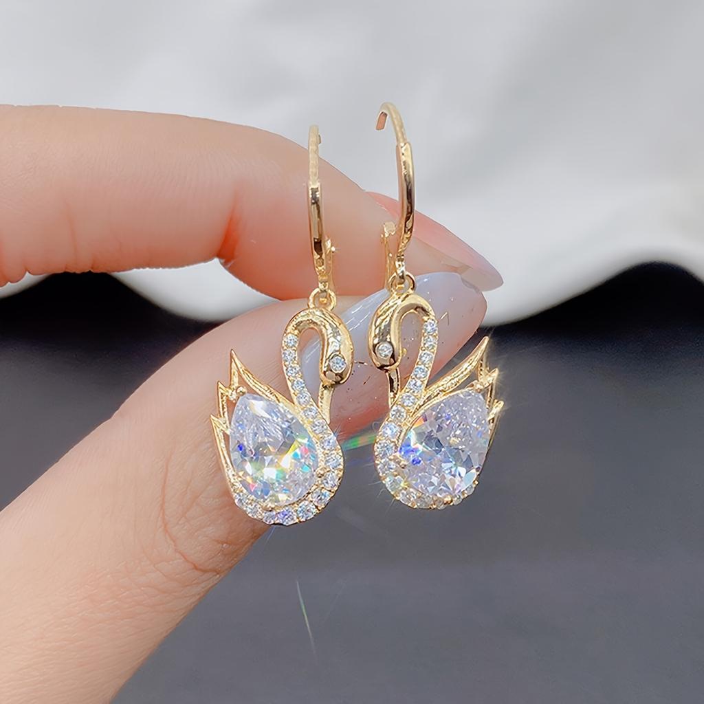 1 Pair of Luxurious Golden-Tone Swan Dangle Earrings with Sparkling Rhinestones - Elegant Zinc Alloy Fashion Jewelry for Women
