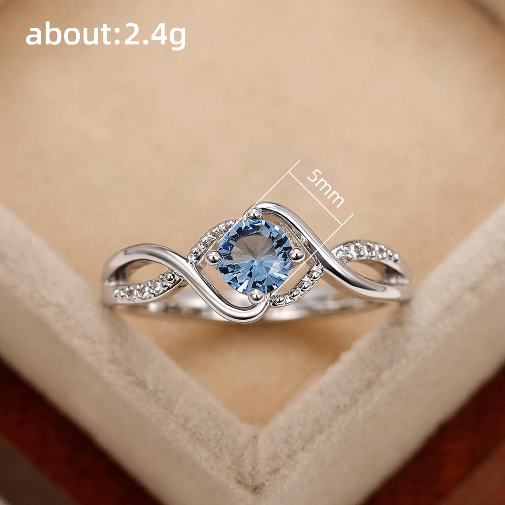 Huitan Elegant Women Ring Twist Design Inlaid Sparkling Blue CZ Fashion Party Engagement Noble Lady Accessories Delicate Jewelry