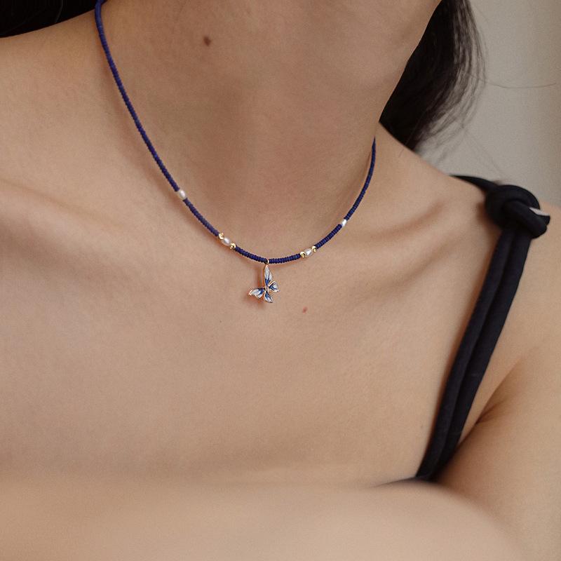 

Dark Blue Beaded Choker Necklace with Blue Enamel Butterfly Charm – Gold Tone Adjustable Dainty Jewelry for Women, Gift