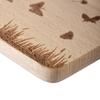 Wooden cutting board with an engraved meadow