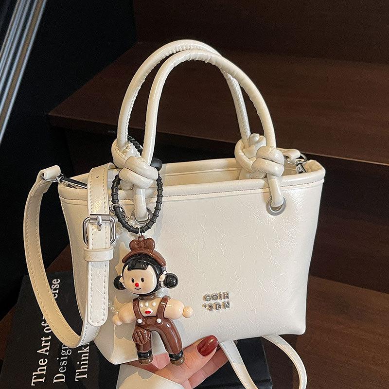 2025 new Korean simple oil wax leather portable bucket bag fashionable versatile solid color foreign style commuter messenger women's bag