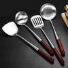 Stainless Steel Spatula with Extended Wooden Handle - High-Temperature Resistant, Anti-Scald Kitchen Utensil for Frying and Stir-Fry Cooking.
