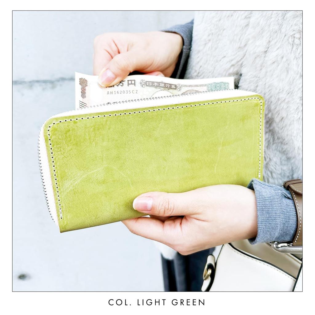 Made in Italy, this genuine Italian leather wallet features a round zipper, card slots, and a bill compartment. Available in light green.