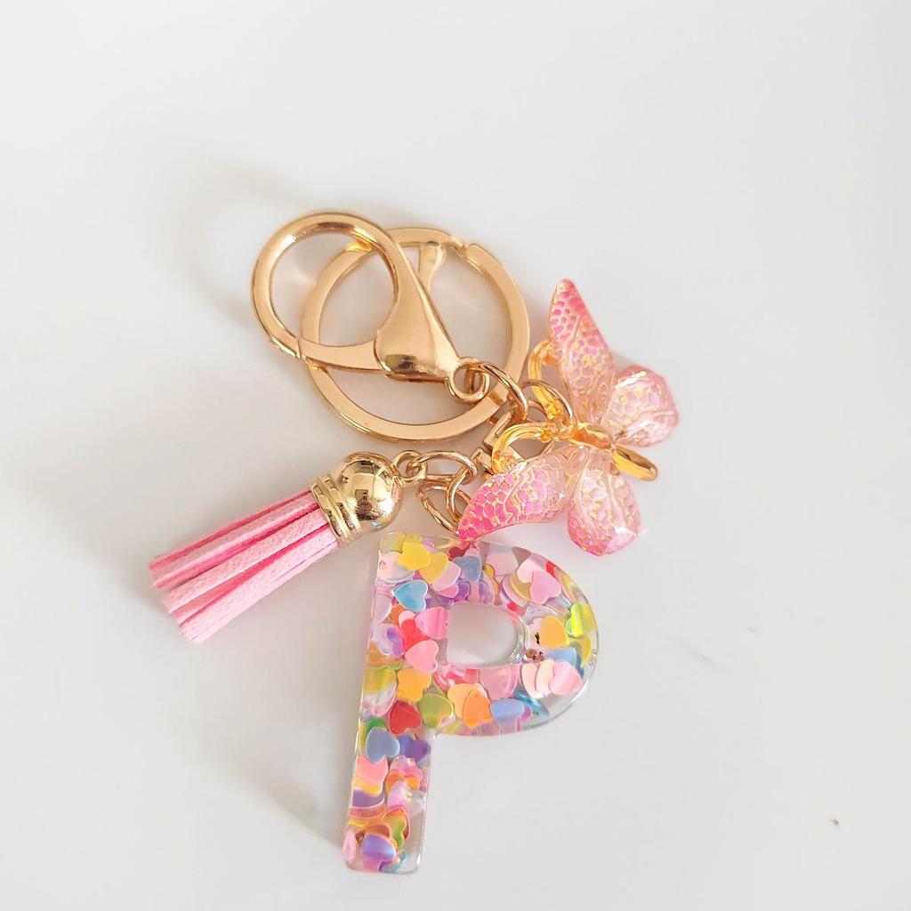 Rosa Glitzer Epoxidharz Schlüsselanhänger mit englischem Buchstaben und Schmetterlingsquaste