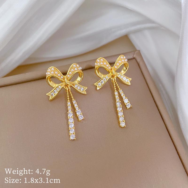 

Комплект ожерелья и серег Легкая роскошь Полный бриллиант Бант Кисточка Индивидуальность Темперамент Банкетные серьги Ожерелье Группа