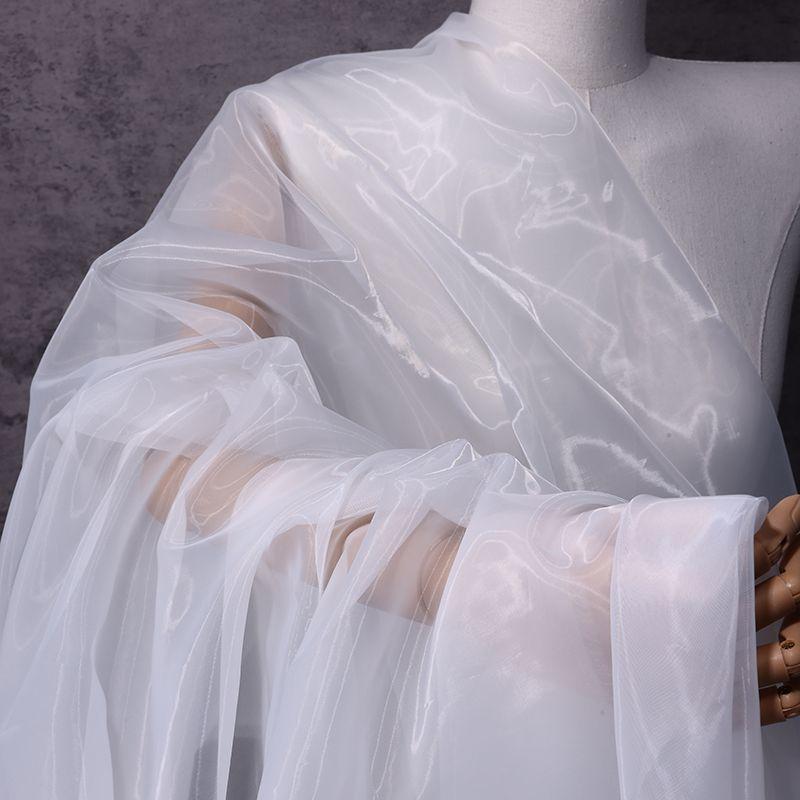The thickened and encrypted soft light organza fabric can be used for wedding dresses evening gowns and designer clothing fabric