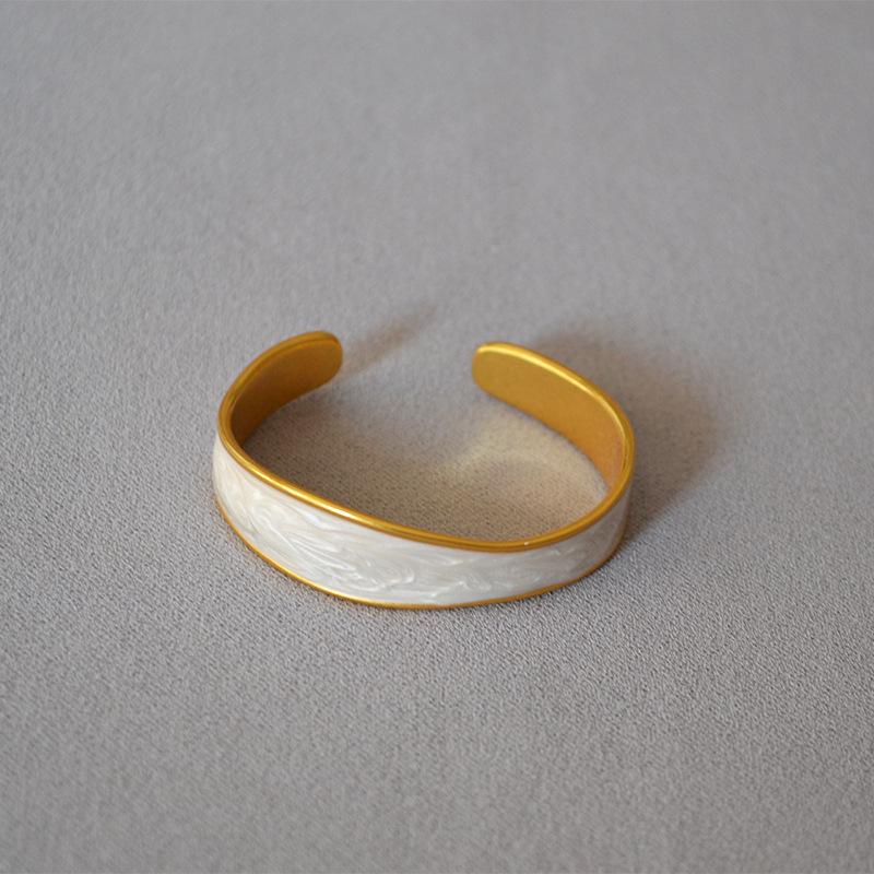 

Heavy Brass Electroplated Gold & White Enamel Adjustable Irregular Bangle for Women