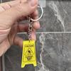 Minimalist 2D Caution Wet Floor Lady Keychain Pendant Backpack Accessory