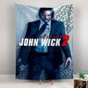 A suited man with a gun stands against a bullet-holed wall. Patterned tapestry for bedroom and living room home decor