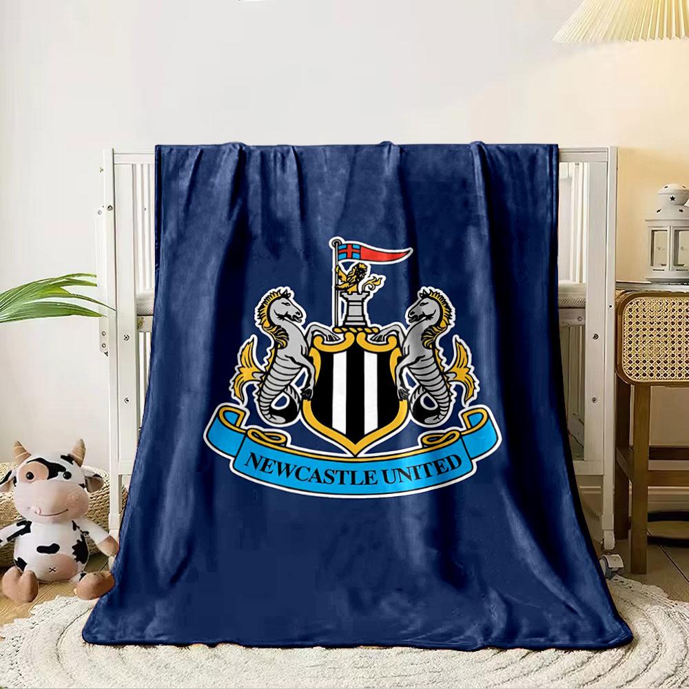 A shield with black and white stripes, flanked by seahorses, and a banner. for all seasons blanket lunch break throw gift