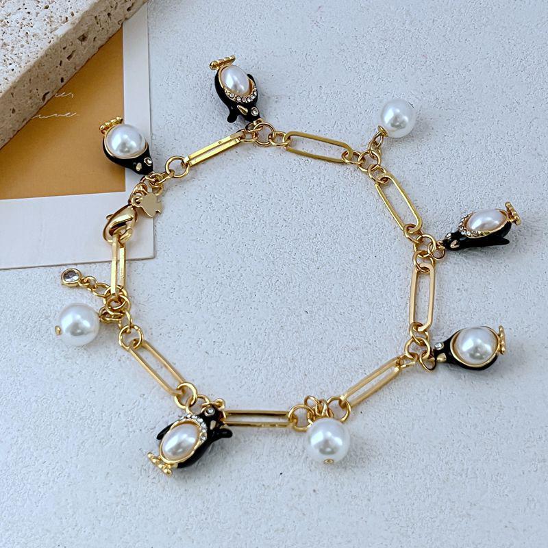 

Elegant Pearl and Enamel Penguin Pendant Bracelet