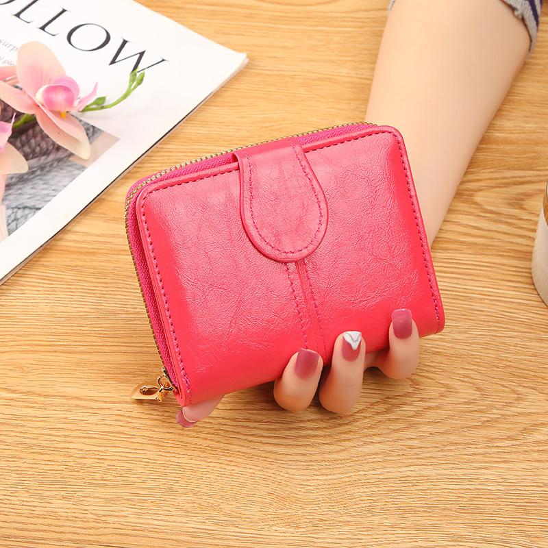 

Short women s wallet new women s oil wax leather retro change bag simple buckle coin bag girls small wallet рожевий червоний колір