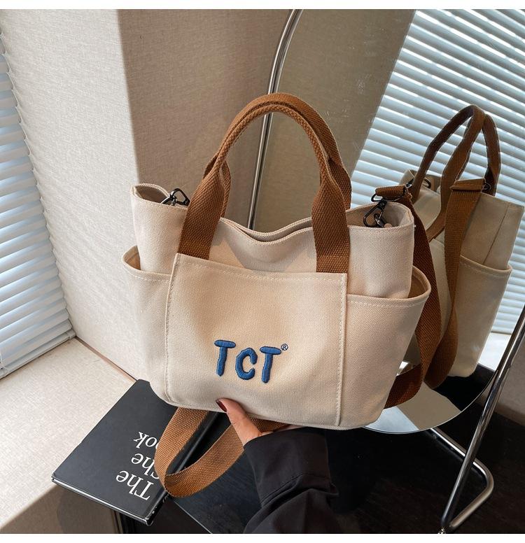 

College style embroidered letter canvas summer 2025 personalized new large capacity commuter shoulder tote bag women