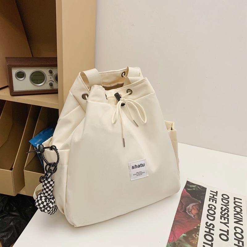 New dual-purpose small backpack, casual niche girlfriend handheld shoulder bag, Japanese and Korean drawstring commuter work backpack