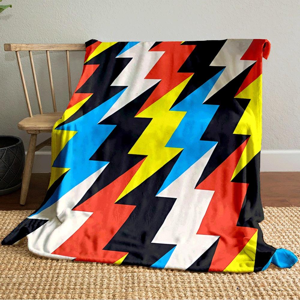 Zigzag lightning shapes in bold colors, including red, yellow, blue, and black. for all seasons blanket lunch break throw gift