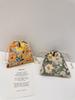 Stylish Floral Drawstring Storage Bag In Gentle Green And Orange Color Combinations For Travel And Organizing Essentials