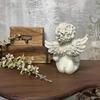 White angel sculpture with a candle