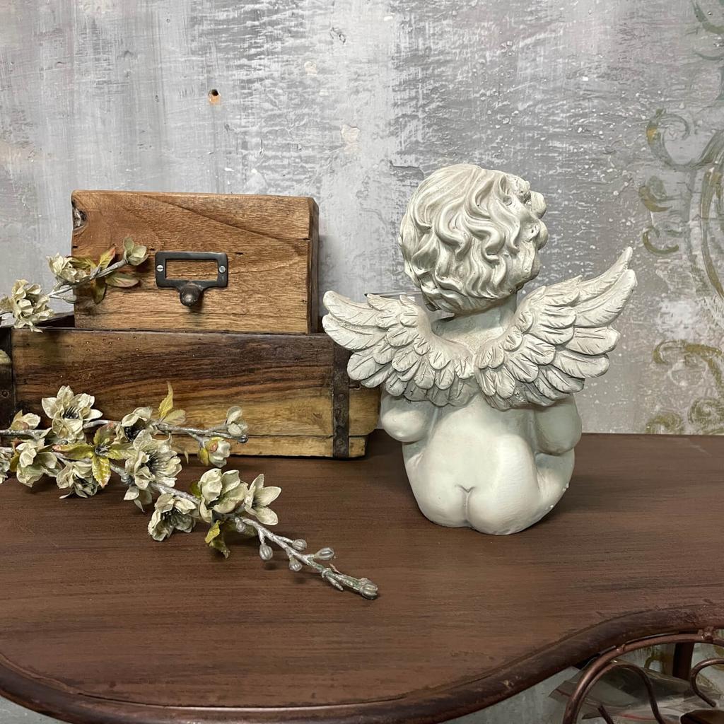 White angel sculpture with a candle
