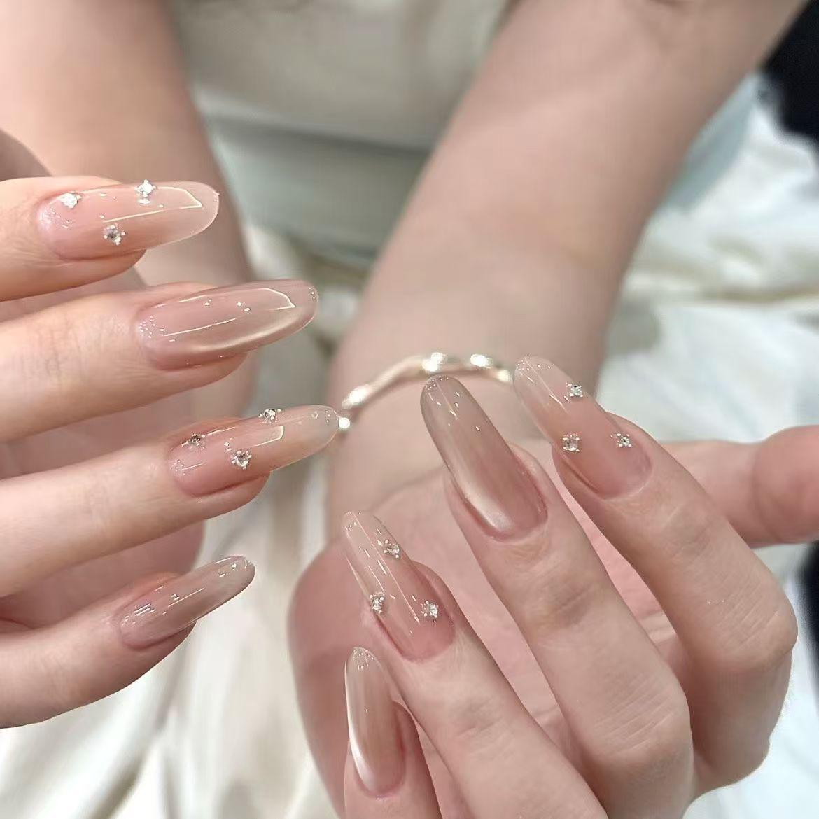 Elegant Handmade Peach Pink Cat Eye Nail Art with Unique Rhinestone Highlights
