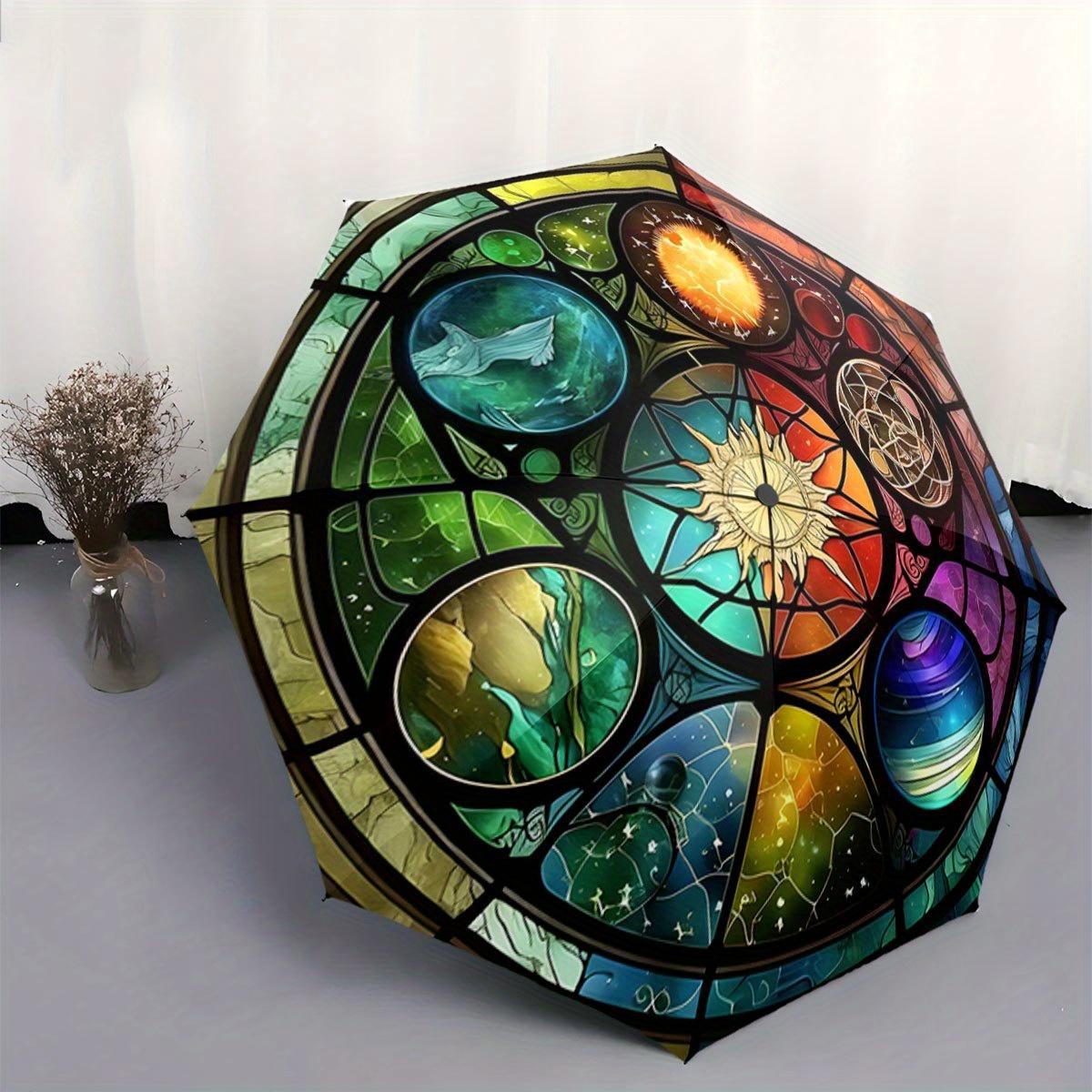 

Automatic Folding Umbrella Stained glass-style celestial design with planets and a sunburst. Portable collapsible design, casu