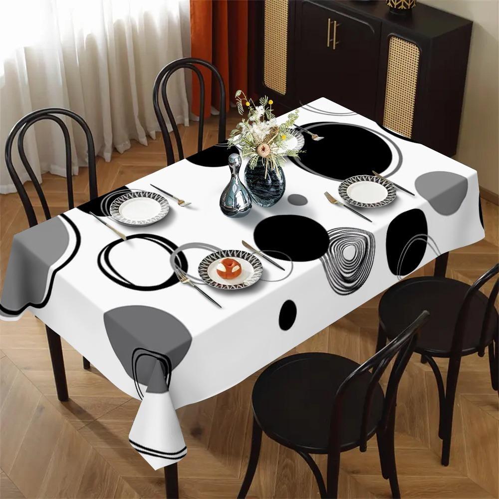 One modern minimalist tablecloth with bold black, white and gray geometric patterns, suitable for indoor and outdoor dining.PMJ