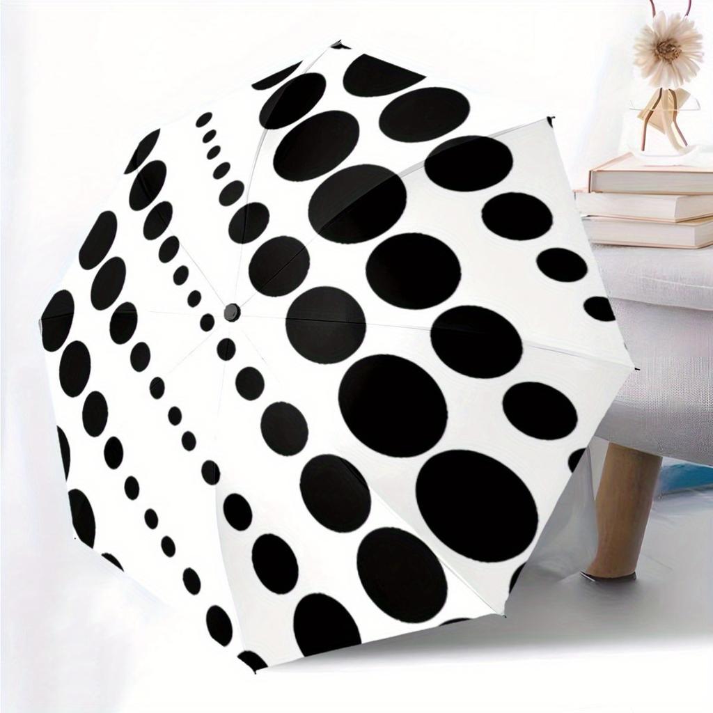 This Is a Portable Automatic Folding Umbrella Featuring Black Polka Dots On a White Backdrop. It'S a Convenient Accessory for