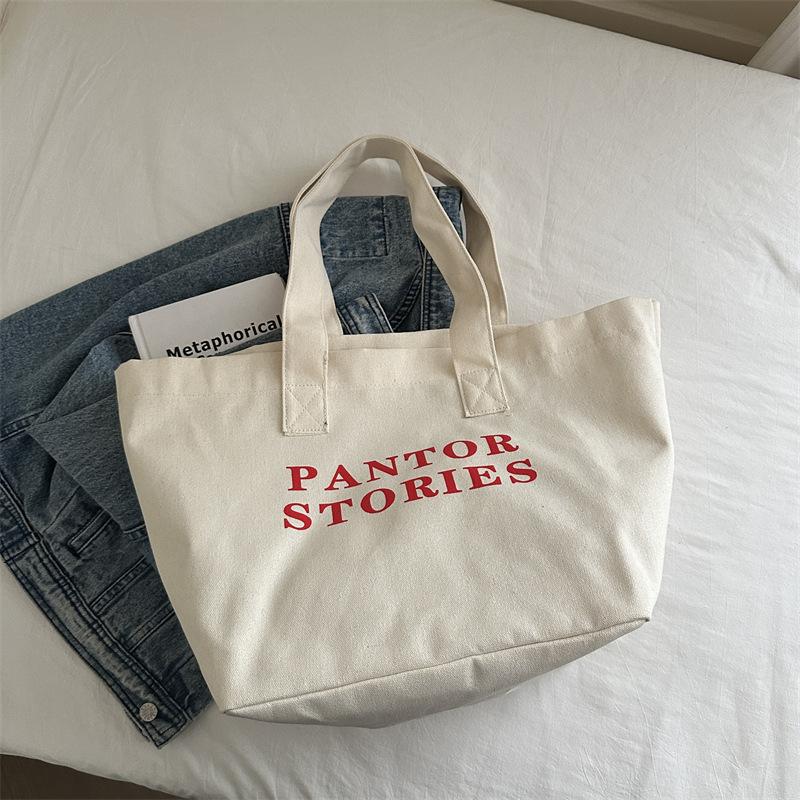 

Нишевая дизайнерская холщовая сумка 2025 осень новая большая вместимость сумка для занятий для студента колледжа повседневная сумка-тоут с надписью белый