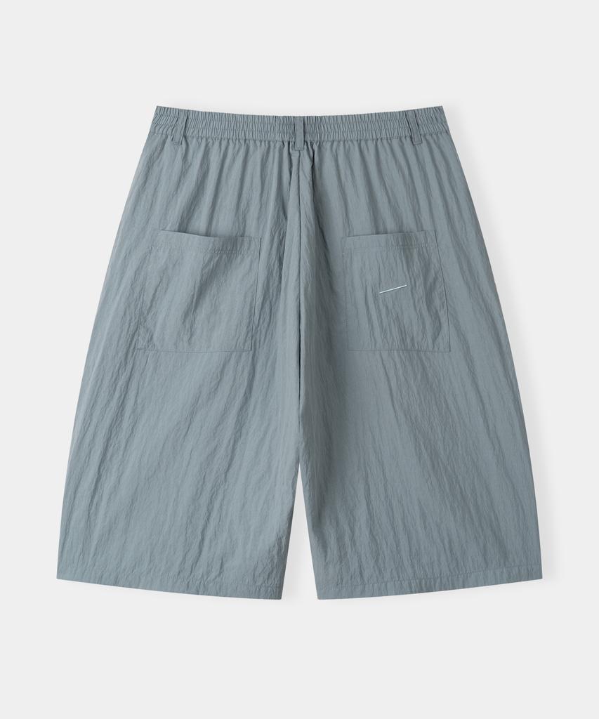Piali Diagonal Pocket Nylon Wrinkle Bermuda Shorts (Graysh Blue)