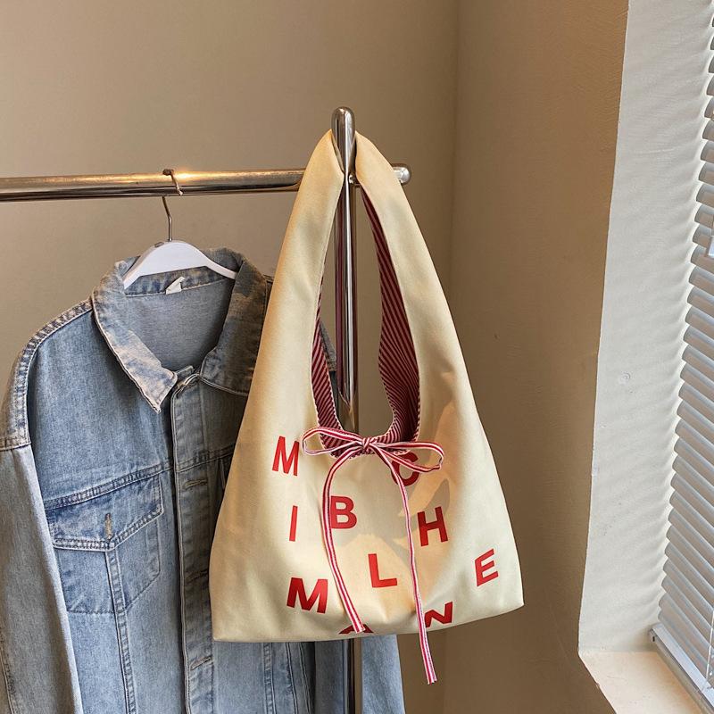 Large capacity double-sided canvas bag women's 2025 new color letter bow shoulder bag fashion student schoolbag