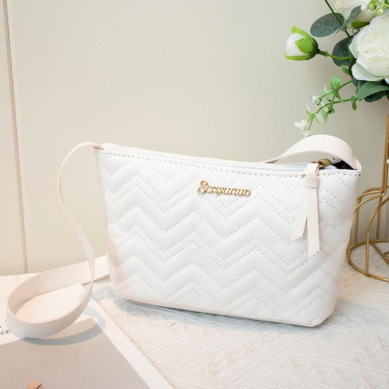 

The new women s bag is a simple shoulder bag, a letter-marked small bag, and a fashionable wavy women s bag. белый