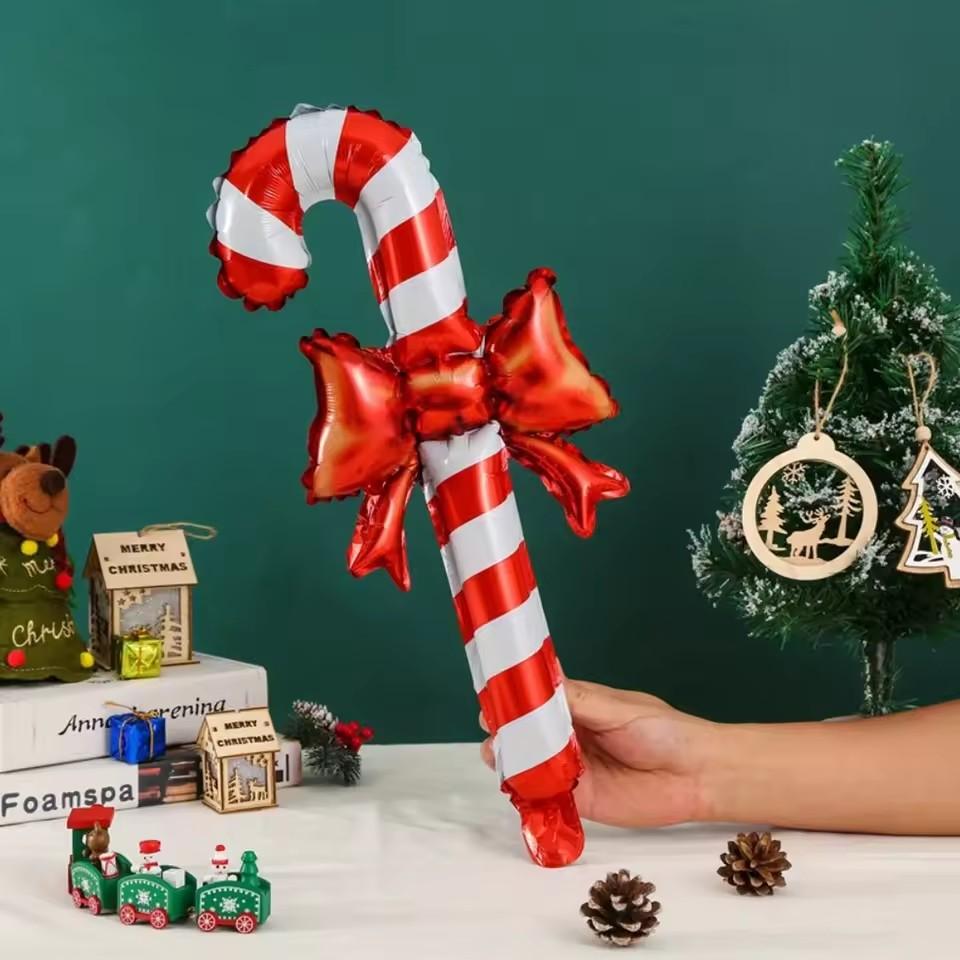 Christmas bows, candy canes, aluminum foil balloons with red and white stripes for a happy Christmas and New Year outfit