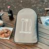 Portable Outdoor Cookware Set: Stainless Steel Cutlery, Storage Bag, and Cutting Board for Camping and Picnics.