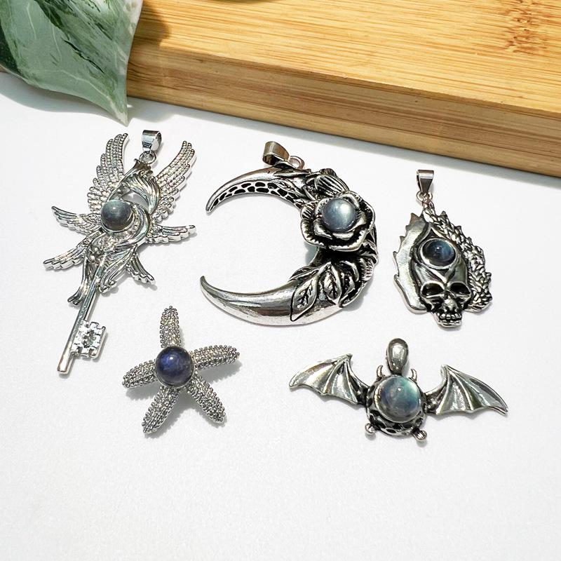 

Retro Literary Moon Pendant with Double Wings, Cross, Skull Charm, and Starfish.
