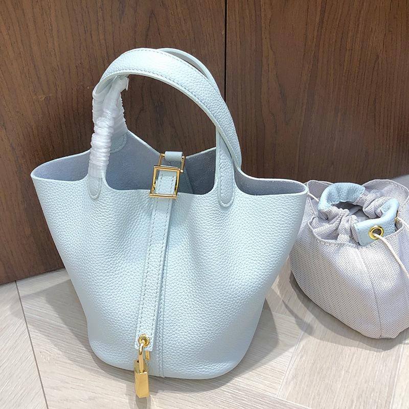 2025 New Style Top Layer Cowhide Vegetable Tanned Leather Bag Sun Blue Water Bottle Bag Togo Leather Handheld Clutch Shoulder Bag Womens Bag