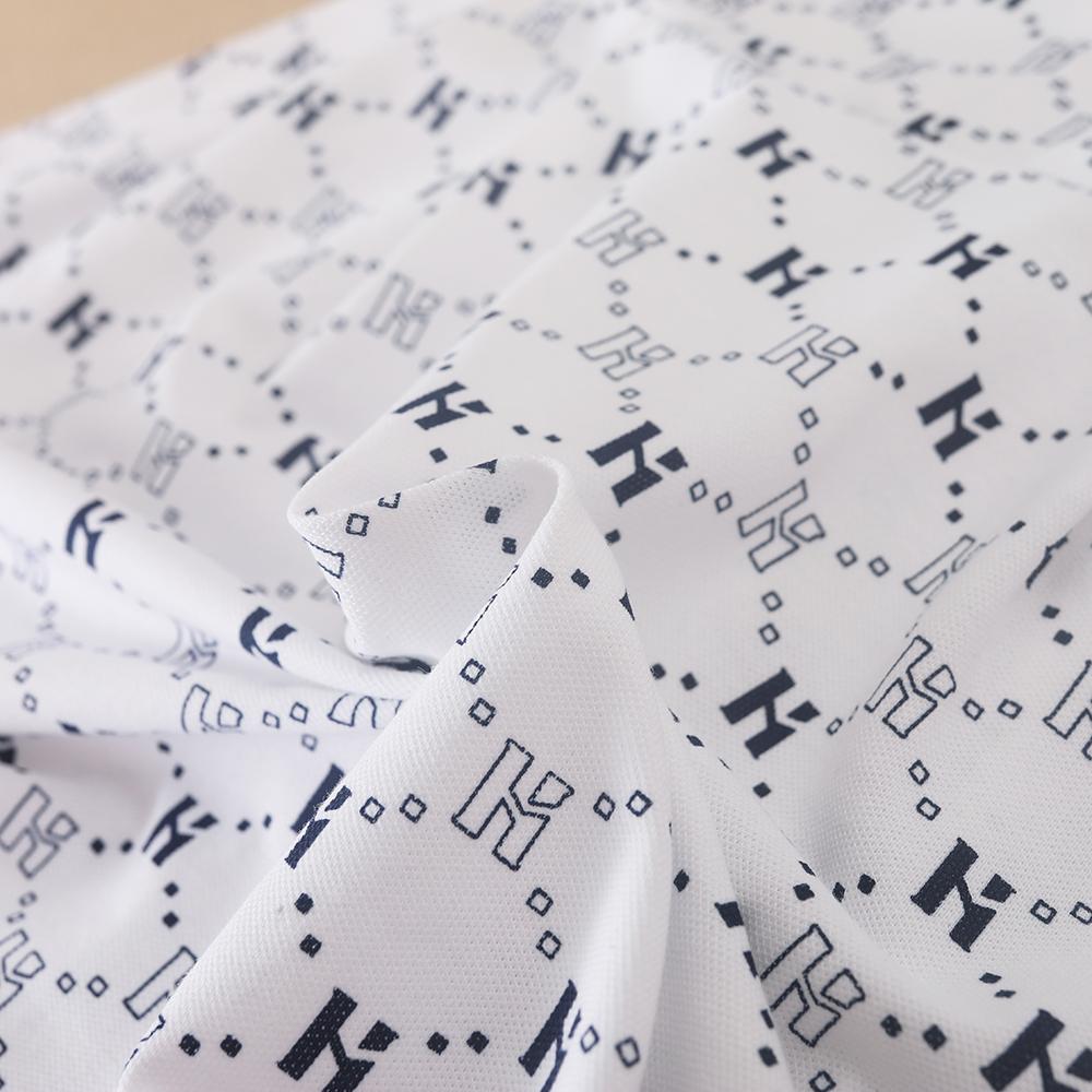 Flickornas tryckta pikétröja klänning med marinblå krage Kortärmad A-linjeformad klänning med monogrammönster Barnvita sommarklänningar