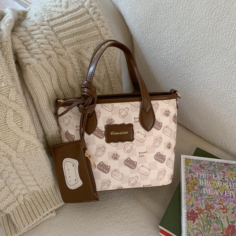 

Stylish and simple cute cat printed portable bucket bag 2025 commuter women s casual foreign style shoulder messenger bag 25*10.5*18