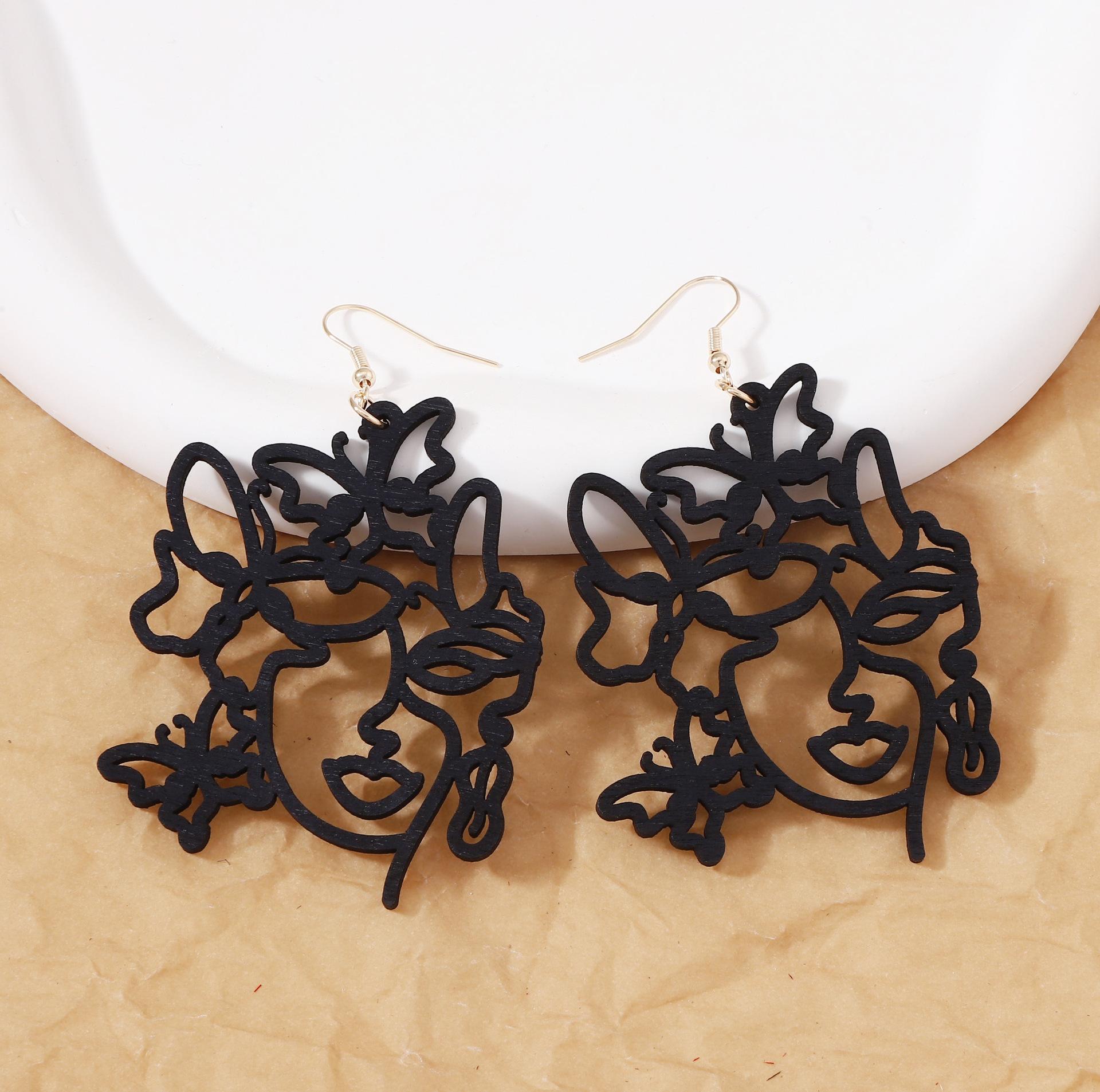 

Niche design sense wooden earrings, laser-cut hollowed-out wooden fun facial imitation earrings