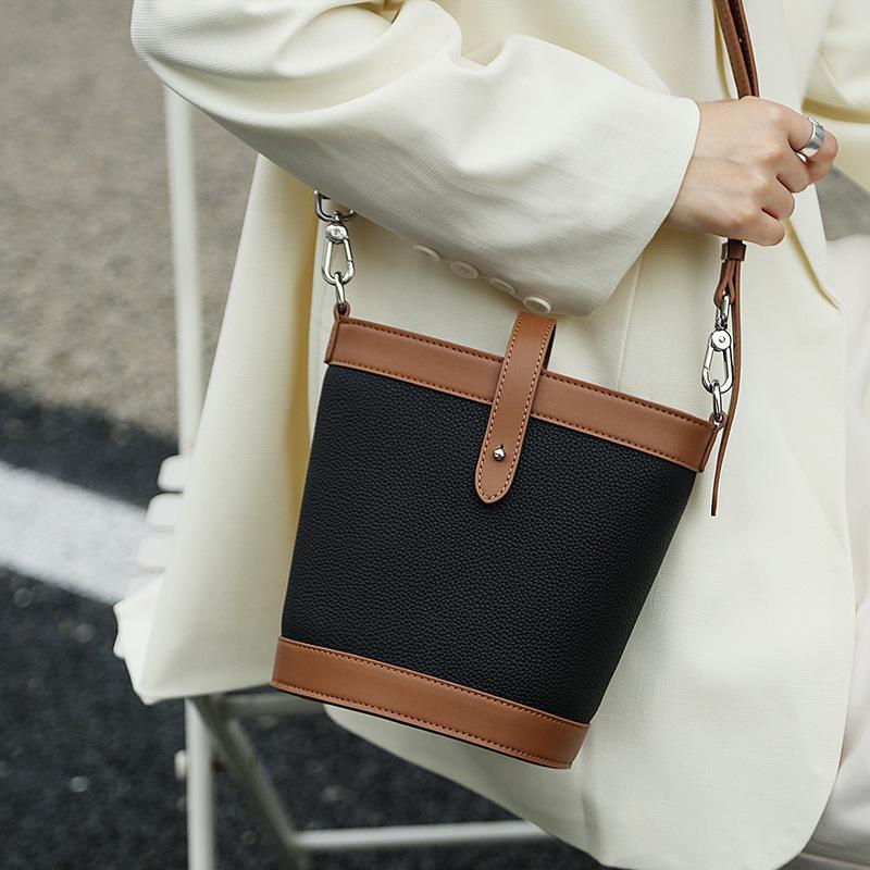 New fashion shoulder messenger bag first layer cowhide women's bag genuine leather contrasting color commuter bucket bag contrasting color design