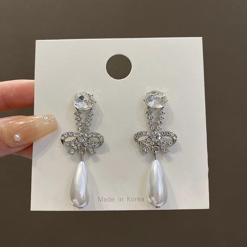 

Flash diamond bow pearl earrings women s niche design sense high-end long earrings exquisite earrings