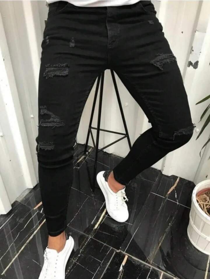 Jeans décontractés ajustés stretch noirs pour homme, principalement déchirés
